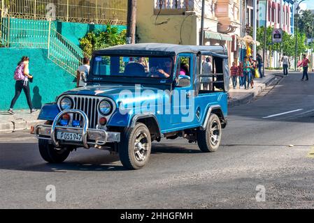 Alte Vintage Willys Jeep fahren in der Innenstadt. Kuba ist bekannt für die Vielfalt der veralteten Fahrzeuge, die immer noch auf seinen Straßen verkehren. Stockfoto