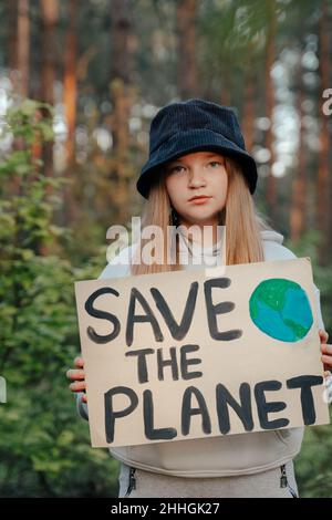 Kind Mädchen Aktivist mit retten den Planeten Poster im Waldpark. Preteen Kind Freiwilligen Kampf gegen Verschmutzung, Globale Erwärmung, Müll zu recyceln. Ecolog Stockfoto