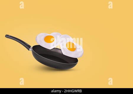 Kreative Idee mit einer Bratpfanne und einem fliegenden Spiegelei in Herzform auf gelbem Hintergrund. Minimales Essen und Liebeskonzept. Frühstücksidee für Valent Stockfoto