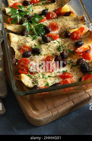 Gebackene Seebarsch-Filets mit Kirschtomaten und Oliven. Direkt darüber. Stockfoto
