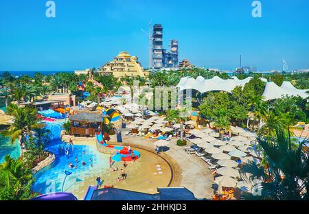 DUBAI, VAE - 7. MÄRZ 2020: Die Pools, der Strand, die Sonnenschirme, der Garten und die Rutschen des Aquaventure Waterpark von Atlantis The Palm Complex, gelegen auf Palm Jume Stockfoto