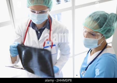 Ärzte in der Klinik betrachten eine Röntgenaufnahme der Lunge Stockfoto