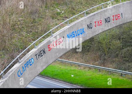 Weymouth, Dorset, Großbritannien. 25th. Januar 2022. Abridge am A354 in Weymouth in Dorset, auf dem eine Graffiti-Nachricht geschrieben wurde, in der es heißt: „klatscht dann geplündert! NHS100K Keine Jabs Keine Jobs! Die Botschaft ist erschienen, da die Frist für die obligatorische Covid-Impfung der NHS-Mitarbeiter durch die Regierungen mit der Frist für den ersten Jab am 3rd. Februar und für die vollständige Impfung bis zum 1st. April 2022 anrückt. Bildnachweis: Graham Hunt/Alamy Live News Stockfoto