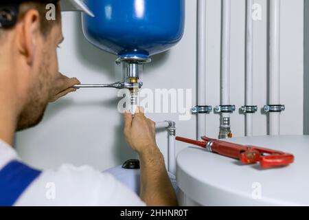 Klempner Installation Expansion Tank für Haus Heizsystem. Sanitär-Service Stockfoto