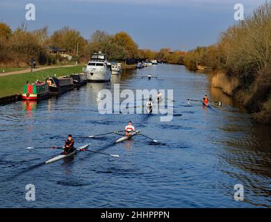 An einem hellen, kühlen und knackigen Wintermorgen passieren eine Flotte von 6 Kanus Kanalboote, die auf dem Gloucester- und Schärfenkanal an der Sellars Bridge festgemacht sind Stockfoto