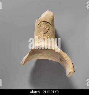 Terrakotta-Amphoren-Fragment mit gestempeltem Griff ca. 180 B.C. Griechisch, Rhodian Es gibt zwei Marken auf dem Bügel. Auf der Oberseite befindet sich ein großer kreisförmiger Stempel mit einem zentralen Rosenemblem; die umlaufende Inschrift gibt den Namen des jährlichen offiziellen Xenophantos und des Monats Sminthios an. Auf der Seite befindet sich ein kleiner quadratischer Stempel mit dem Buchstaben B, der die Zahl 2 repräsentiert.die Inschrift lautet Ἐπι Ξενοφαντου Σμινθίου. Terrakotta-Amphoren-Fragment mit gestempeltem Griff 241974 Stockfoto