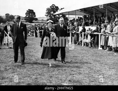 Königin Elizabeth II. Besucht Wales. Die Königin mit dem Herzog von Edinburgh und dem Ratsmitglied John de Winton, der Präsident der Brecknockshire Agriculture Society Show ist, beim Spaziergang durch das Ausstellungsgelände von Brecon. 6th. August 1955. Stockfoto