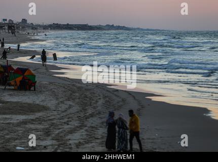 Gaza, Palästina. 25th Januar 2022. Palästinenser genießen die Küste bei Sonnenuntergang im Westen von Gaza City. Kredit: SOPA Images Limited/Alamy Live Nachrichten Stockfoto