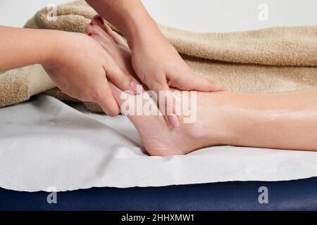 Eine professionelle Masseurin massiert ihre Kundin Stockfoto