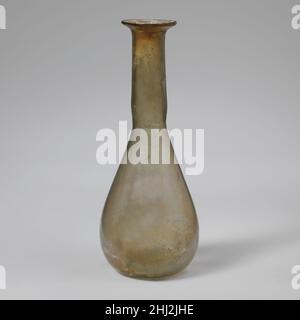Parfümflasche aus Glas 1st. Jahrhundert n. Chr. römisch Durchscheinend hellgelb grün.einfacher, abgerundeter Rand; abfackelnder Mund; zylindrischer Hals, leicht nach unten ausdehnend und mit Werkzeugnuten um den Boden; länglicher konischer Körper mit konvexen Seiten; leicht konkaver Boden.intakt; einige Blasen und schwarze Verunreinigungen; Flecken von Abstumpfen und Verwitterung; Irideszenz.. Parfümflasche aus Glas 239643 Stockfoto