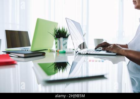 Ethnischer Mann mit Laptop im Büro Stockfoto