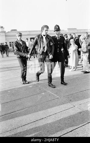 Mods gegen Rockers. Bild zeigt die Szene in Margate, North East Kent im Mai 1964. Ein Jugendlicher wird von der Polizei in Handschellen gelegt und weggebracht. Foto vom 17th. Mai 1964 Stockfoto