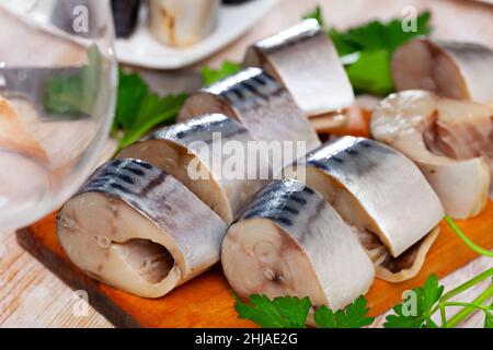 Gesalzener scomber auf Holzbrett mit Grüns Stockfoto