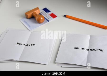 Auf dieser Fotolabbildung sind Stimmzettel von Marine Le Pen und Emmanuel Macron auf einem Tisch mit Wählerkarte, Stempel und Stift zu sehen. Obwohl Emmanuel Macron offiziell kein Kandidat für die Wiederwahl ist, führt der Präsident der Französischen Republik, Emmanuel Macron, mit 25 % der Wahlabsichten die Umfragen für die Präsidentschaftswahlen 2022 an, was ihn vor Marine Le Pen von der Partei Rassemblement National (RN oder National Rally) stellt, Die nur 17 % befragten. Die erste Runde der französischen Präsidentschaftswahlen findet am 10. April 2022 statt. Stockfoto