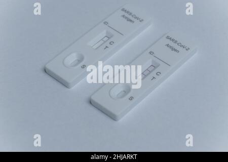 Zwei positive und negative SARS Covid 19 Coronavirus Antigen Schnelltests auf weißem Hintergrund Stockfoto