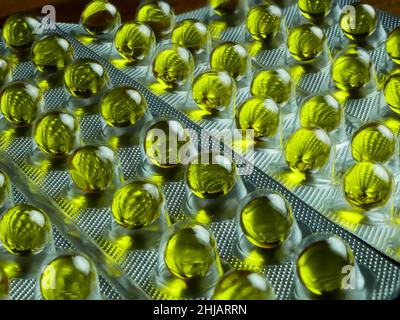 Transparente kleine gelbe Pillen in Blister. Vitamin Stockfoto