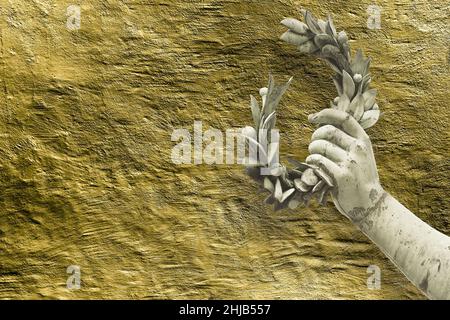 Hand hält einen Lorbeerkranz - Bronzestatue auf goldenem Hintergrund - Erfolg und Ruhm Konzeptbild mit Kopierraum. Stockfoto