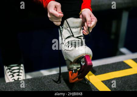 Pasay City, Pasay City. 21st Januar 2022. Nikki Cheng, 29, Präsidentin der philippinischen Skating Union und Mitglied der philippinischen Delegation bei den Olympischen Winterspielen in Peking, zog am 21. Januar 2022 ihre Schlittschuhe in einem Einkaufszentrum in Pasay City auf den Philippinen an. DAZU: Feature: Mit Blick auf das Eis, mehr junge Filipinos nehmen über Beijing 2022 Wintersport an. Quelle: Rouelle Umali/Xinhua/Alamy Live News Stockfoto