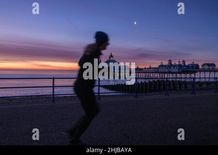 Vereinigtes Königreich Wetter Eastbourne, East Sussex, 28th Jan 2022. Ein Jogger läuft, während die Sonne über Eastbourne Beach, East Sussex, UK, aufgeht.Alamy Live News Credit: Reppans/Alamy Live News Stockfoto