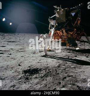 Die Apollo-11-Astronauten Neil Armstrong und Edwin 'Buzz' Aldrin führten am 20. Juli 1969 die erste bemannte Mondlandung durch. Hier setzt Buzz den Solar Wind Collector ein, ein Folienblatt, das er auf die Sonne zeigt. Am Ende der EVA, nachdem er den SWC etwa 1 Stunden und 17 Minuten lang der Sonne ausgesetzt hatte, Buzz wird die Folie zusammenrollen und in einen Beutel packen, um sie auf der Erde zu analysieren. Beachten Sie den beträchtlichen Abstand zwischen der Unterseite der Glocke des Abfahrmotors und der darunter liegenden Oberfläche.