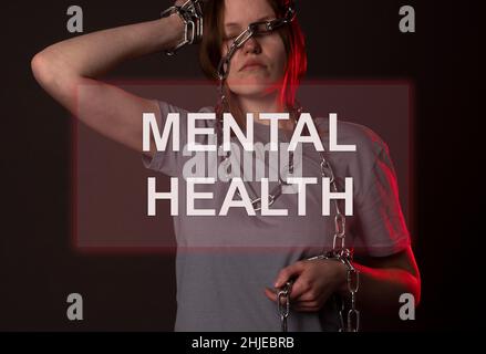 Aufschrift der psychischen Gesundheit auf dem Foto einer Frau in Ketten. Stockfoto