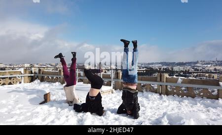 Junge Israelis stehen auf dem Kopf, während sie den Schneefall am 27. Januar 2022 in Jerusalem, Israel, genießen. Jerusalem wurde über Nacht von Schnee bedeckt, der 10 bis 20 Zentimeter (vier bis acht Zoll) erreichte. Stockfoto