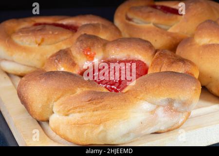 Süße Pasteten mit Marmelade auf dem Tisch. Essen auf schwarzem Hintergrund Stockfoto
