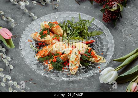 Dünne Pfannkuchen mit Kaviar und Lachs, zu Rollen gerollt. Stockfoto