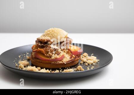 Pfirsich-Schuster mit gerinnter Creme und kandierten Pekannüssen Stockfoto