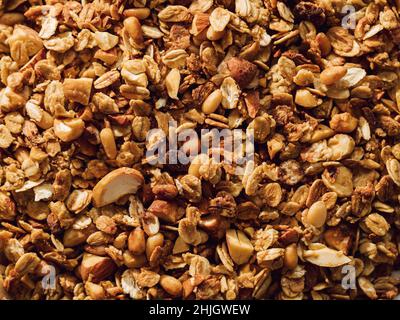 Glutenfreies Hafergranola mit Nüssen. Granola-Textur mit Kopierraum. Textur Haferflocken Müsli oder Müsli als Hintergrund, Draufsicht oder flach liegend Stockfoto