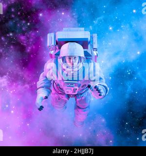 Friedliche weibliche Astronautin - 3D Illustration einer Frau im Weltraumanzug, die in einer sanft leuchtenden rosa und blauen galaktischen Wolke schwebt Stockfoto