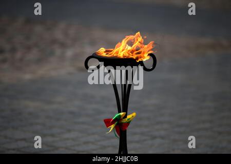 Im Freien brennen dekorative Fackeln mit Gläubigen Flieder, die in den Farben der litauischen Staatsflagge dekoriert sind Stockfoto