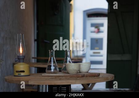 Travel Denmark: Restauranttische mit Schüsseln und Flaschen in einem offenen Hinterhof in Ribe Stockfoto