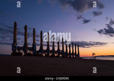 Buntes Klebeband auf den Holzsäulen im heiligen burjat-Platz auf Kap Burkhan im Dorf Khuzhir auf der Insel Olchon, Baikalsee, Russland Stockfoto