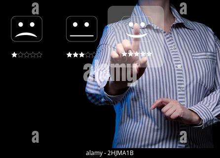 Benutzerbewertungen und Bewertung der Unternehmensleistung. Bewertung von Produkten und Dienstleistungen. Eine Frau in einem gestreiften Hemd trifft eine Bewertungsentscheidung Stockfoto