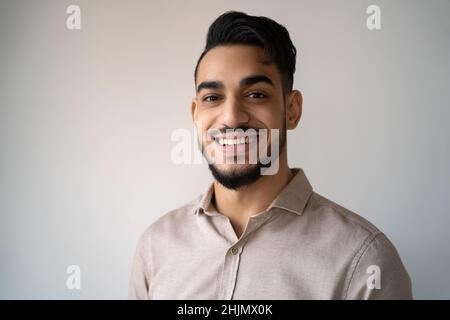 Kopfbild eines jungen Erwachsenen, lächelnden indischen Mannes über einem leeren Kopierraum Stockfoto