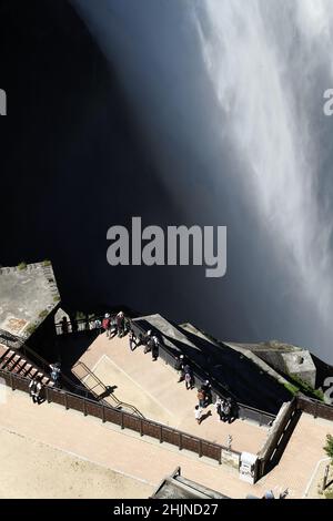 Nagano, Japan, 2021-23-07 , Menschen beobachten die Wasserstrahlen des Staudamms von einer Terrasse am Kurobe-Staudamm in Nagano, japan. Der Kurobe-Staudamm oder der Kuroyon-Staudamm, i Stockfoto