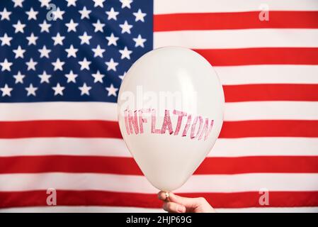 Wirtschaftskrise und Inflationskonzept, Ballon mit Wortinflation gegen us-Flagge, steigende Preise für Konsumgüter und Dienstleistungen Stockfoto