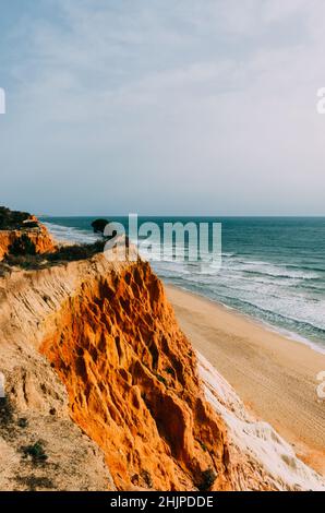 Strand von Falesia in Albufeira, Algarve-Region, Portugal. Der Strand ist von hohen Kalksteinfelsen umgeben und kann nur über ein paar Treppen erreicht werden. Stockfoto