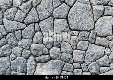 Textur einer grauen Steinwand. Textur Hintergrund der Steinmauer des alten Schlosses. Steinmauer als Hintergrund oder Textur. Stockfoto
