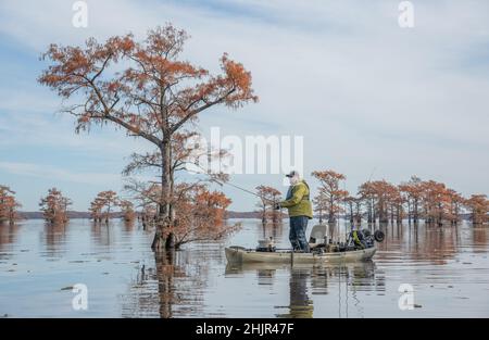 Mann, der im Herbst auf dem See angeln wird Stockfoto