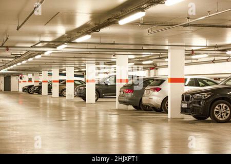 Tiefgarage in einem modernen Gebäude mit Reihe von Autos. Kopenhagen, Dänemark - 20. Mai 2020. Stockfoto
