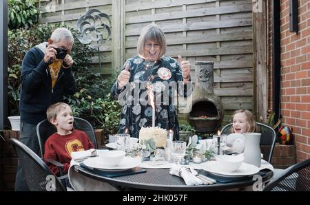 Frau in den 70ern feiert ihren Geburtstag mit ihrer Familie Stockfoto