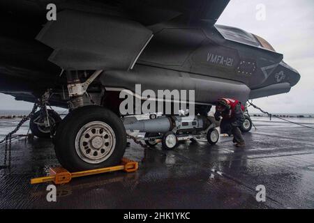 PHILIPPINISCHES MEER (Jan 29, 2022) Cpl. Antonio Sanchez, aus Douglasville, Georgia, der Marine Expeditionary Unit (MEU) von 31st zugewiesen, entlädt auf dem Flugdeck des nach vorne eingesetzten amphibischen Angriffsschiffs USS America (LHA 6) die Kampftanz eines F-35B Lightning II-Kampfflugzeugs der MEU von 31st. Amerika, Flaggschiff der America Amphibious Ready Group, arbeitet zusammen mit der 31st MEU im Verantwortungsbereich der US-Flotte für 7th, um die Interoperabilität mit Verbündeten und Partnern zu verbessern und als einsatzbereite Einsatztruppe für Frieden und Stabilität in der Indo-Pazifik-Region zu dienen. (USA Navy Pho Stockfoto