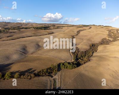 Luftpanorama auf den Hügeln des Val d'Orcia in der Nähe von Pienza, Toskana, Italien. Toskanische Landschaft mit Zypressen, Weinbergen, Wäldern und gepflügten Feldern Stockfoto