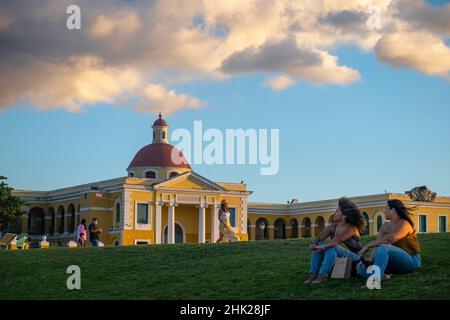 Frauen sitzen vor der Escuela de Artes Plásticas y Diseño de Puerto Rico, San Juan, Puerto Rico Stockfoto