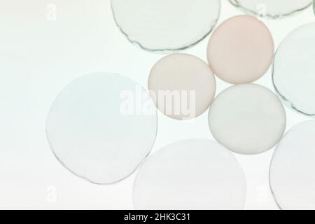 Klarglas und beigefarbene Kieselsteine aus Glas mit Licht Stockfoto