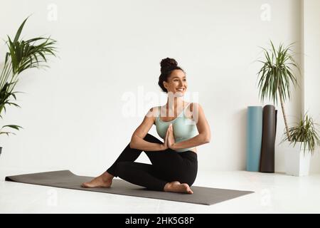 Portrait Of Beautiful Young Female Making Yoga Practice In Light Studio Stockfoto