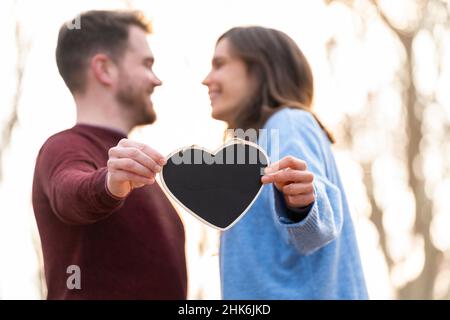 Porträt eines Paares mit einer herzförmigen Tafel Stockfoto