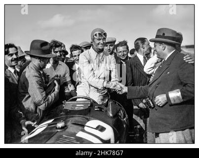 Jahrgang 1930s Grand Prix Frankreich Louis Chiron in einem Alfa Romeo, der vom Schaltungsbeamten nach dem Gewinn des Grand Prix von Frankreich 1934 gratuliert wurde 1. Juli 1934 XXVIII Grand Prix de l'Automobile Club de France Autodrome de Montlhéry Stockfoto